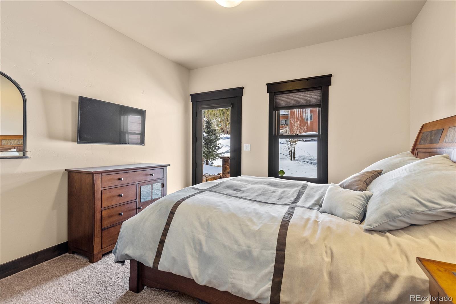 68 Independence Road Keystone, CO 80435 - Photo 25 of 34 a bedroom with a large bed and a flat tv screen on dresser