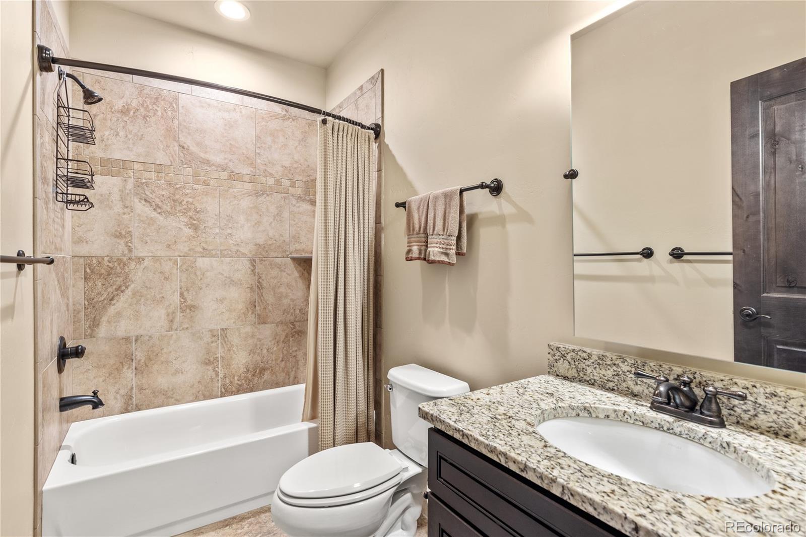 68 Independence Road Keystone, CO 80435 - Photo 26 of 34 a bathroom with a granite countertop sink toilet and shower