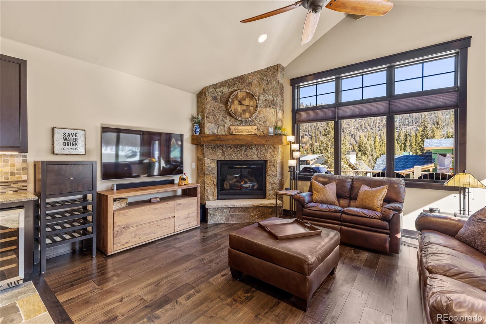 68 Independence Road Keystone, CO 80435 - Photo 5 of 34 a living room with furniture a fireplace and a large window