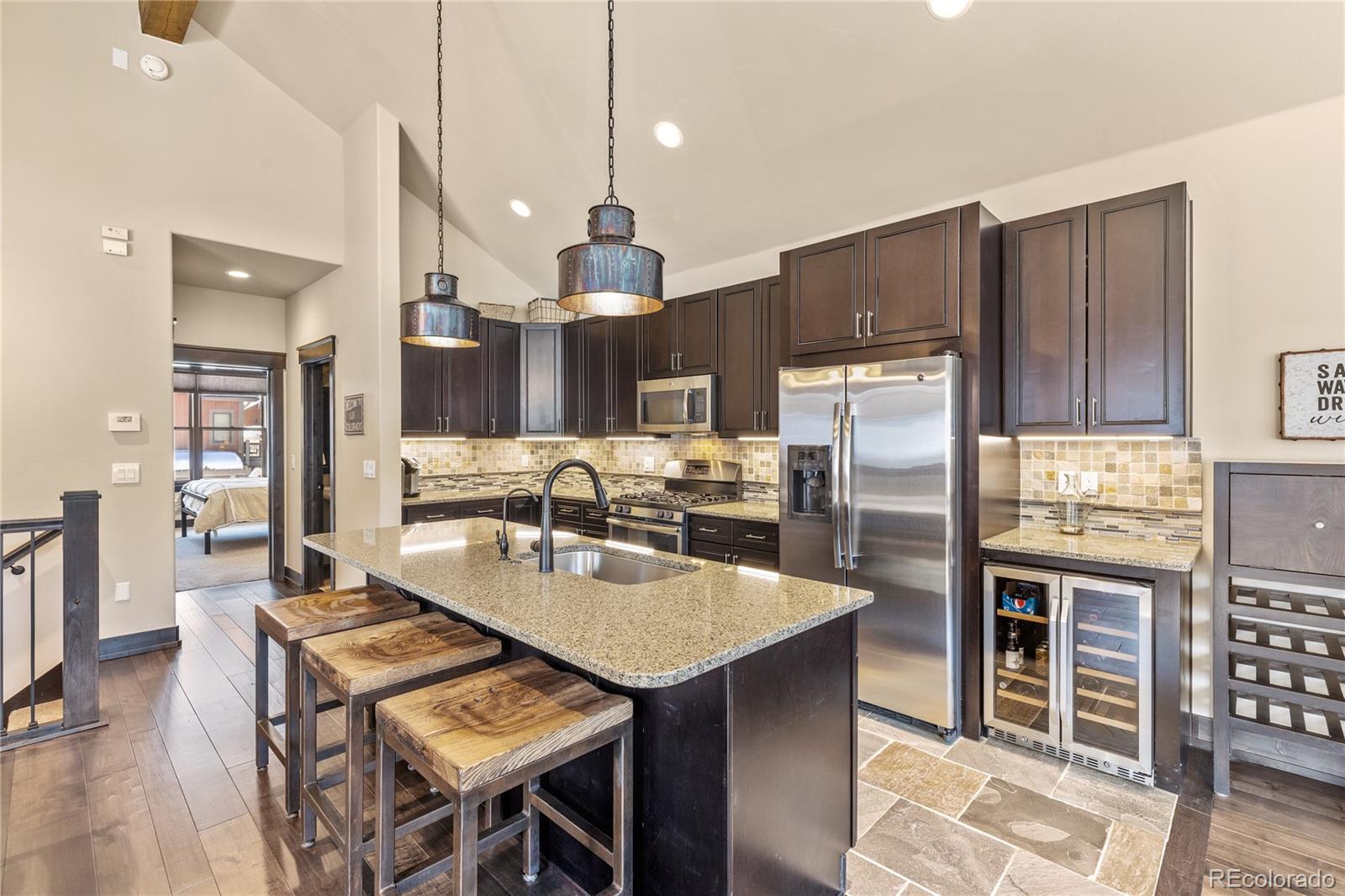 68 Independence Road Keystone, CO 80435 - Photo 6 of 34 a kitchen with stainless steel appliances granite countertop a refrigerator a stove a sink a dining table and chairs