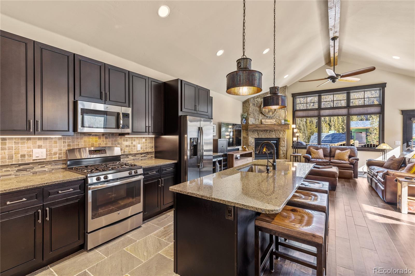 68 Independence Road Keystone, CO 80435 - Photo 7 of 34 an open kitchen with wooden floor and stainless steel appliances