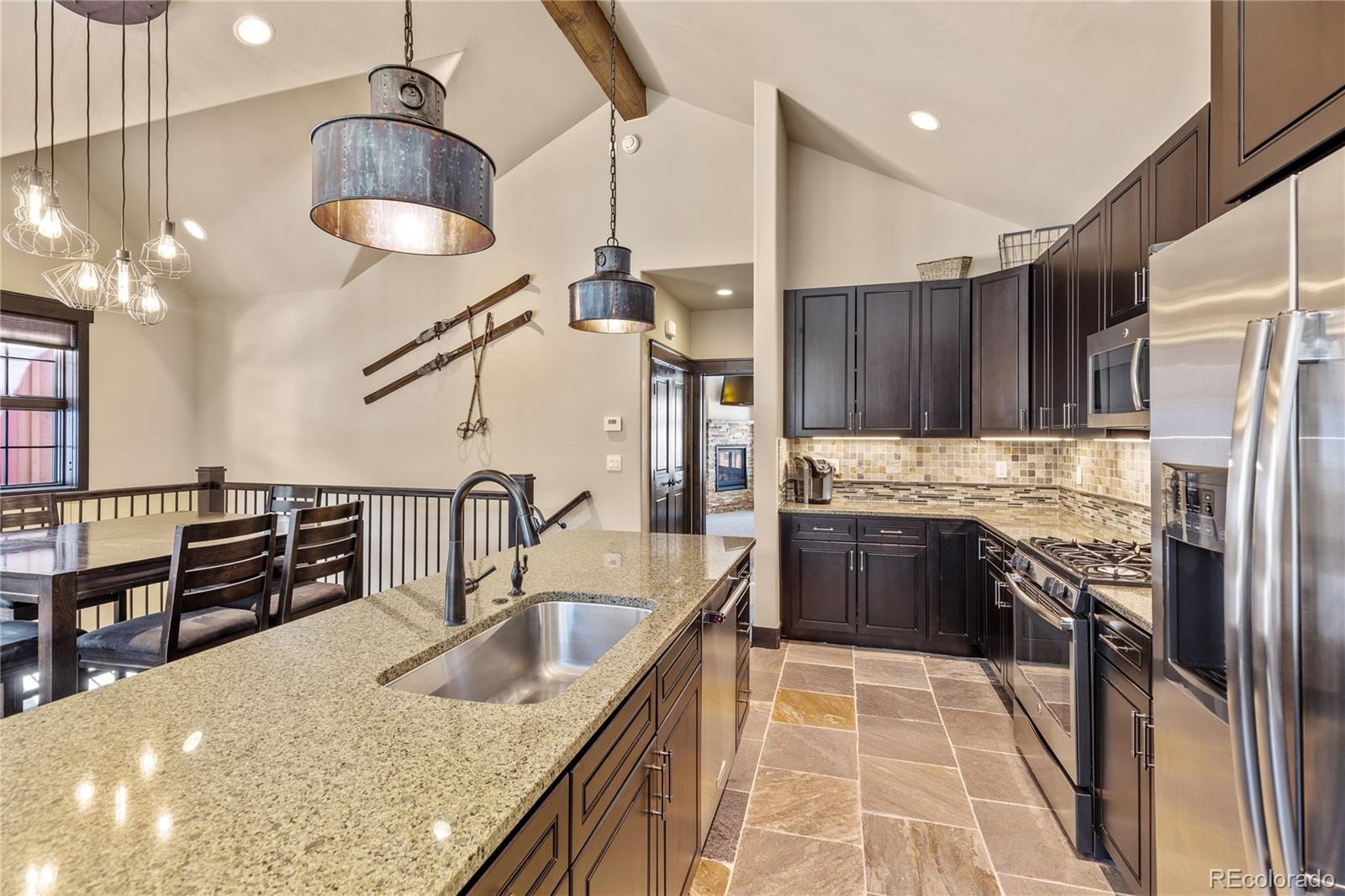 68 Independence Road Keystone, CO 80435 - Photo 8 of 34 a kitchen with stainless steel appliances granite countertop a sink refrigerator and cabinets