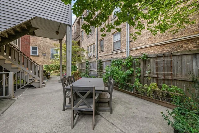 a view of a patio with table and chairs and potted plants