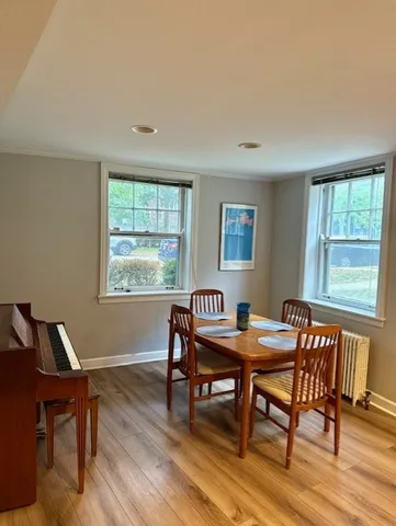 a dining room with a wooden table and chairs