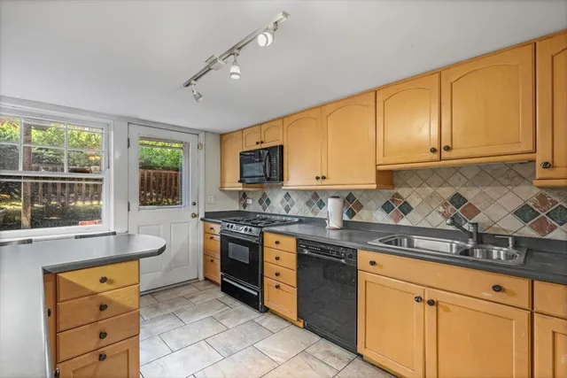 a kitchen with stainless steel appliances granite countertop a stove sink and cabinets