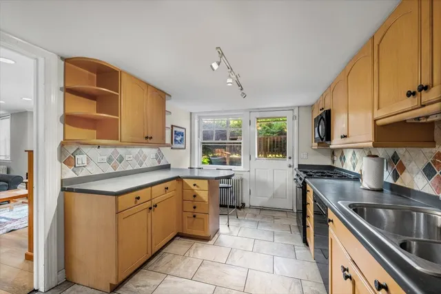 a kitchen with a sink stove and cabinets