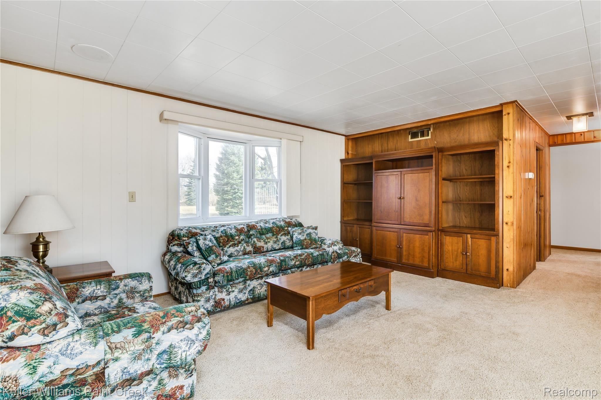 4770 Whipple Lake Road Clarkston, MI 48348 - Photo 2 of 21 The generous living area offers picturesque views and real knotty wood.