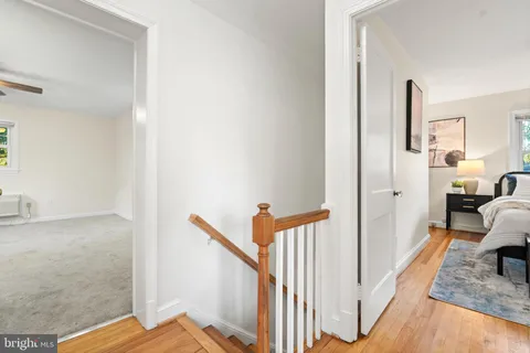 a view of a hallway with a livingroom and entryway
