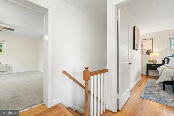 a view of a hallway with a livingroom and entryway