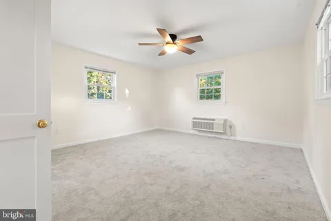 a view of a livingroom with a ceiling fan and window