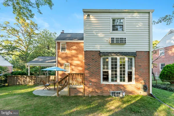 a view of a house with a yard and sitting area