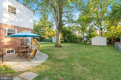 a view of a table and chairs under an umbrella