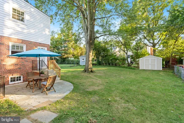 a view of a table and chairs under an umbrella