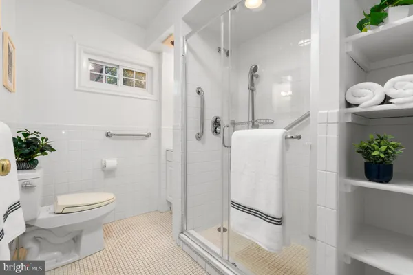 a bathroom with a shower a toilet and a shower