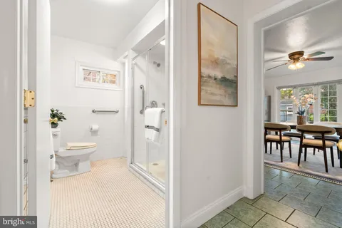 a bathroom with a toilet a sink and a mirror