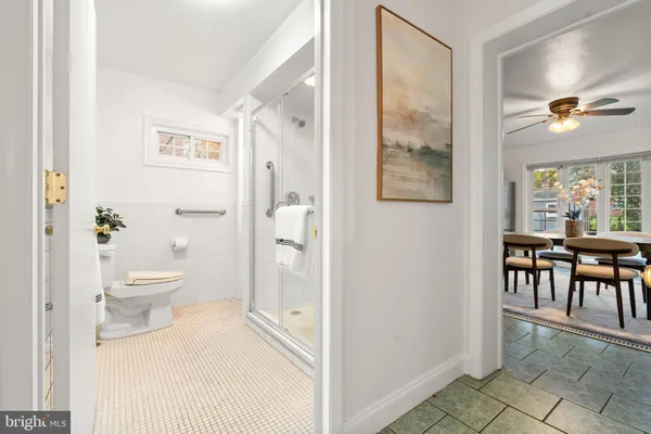 a bathroom with a toilet a sink and a mirror