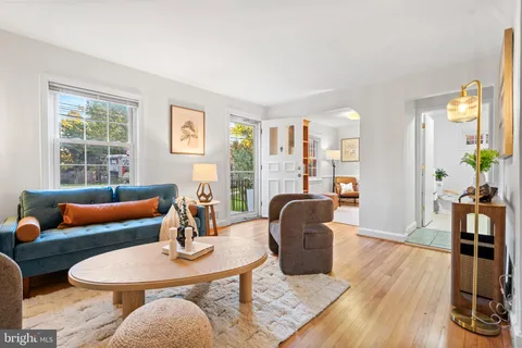 a living room with furniture rug and wooden floor