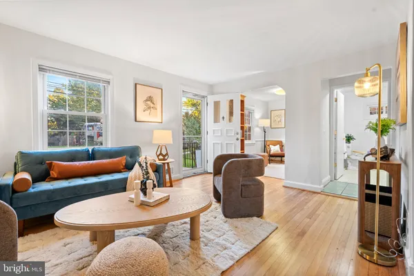 a living room with furniture rug and wooden floor