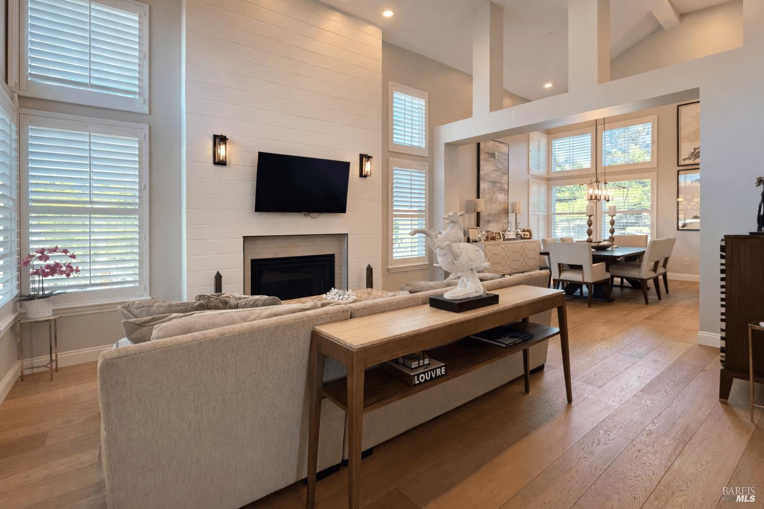 3726 Cannes Place Santa Rosa, CA 95403 - Photo 10 of 68 The large living room also has a gas fireplace. The owners are including the wall mounted flatscreen in the sale, as well as the other wall mounted flatscreens in other rooms. Look at this beautiful wide plank wood flooring!