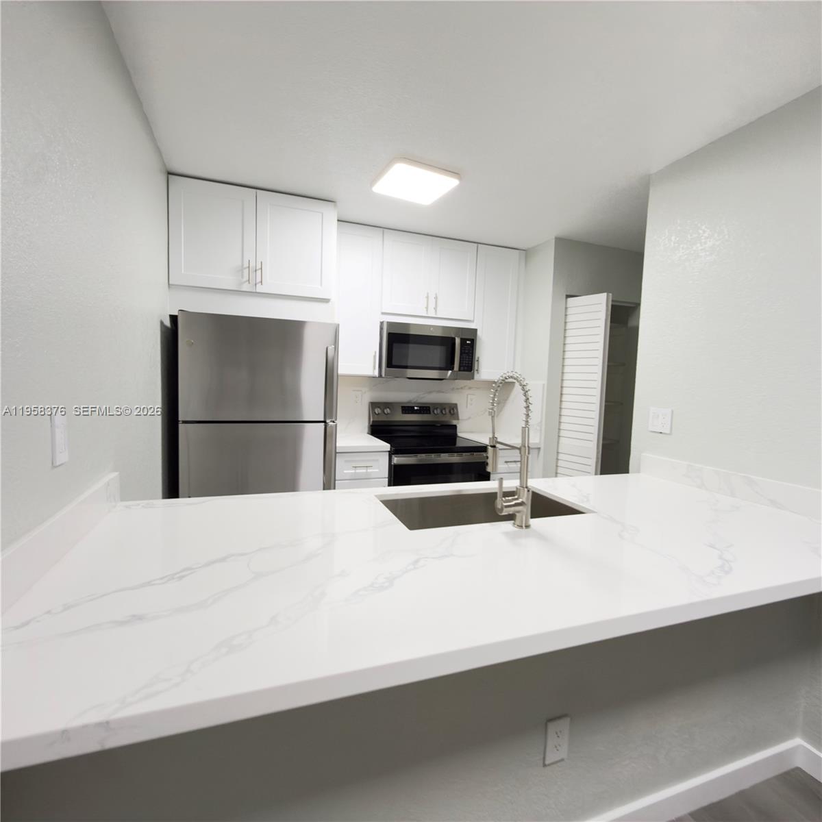 a kitchen with a refrigerator and a sink