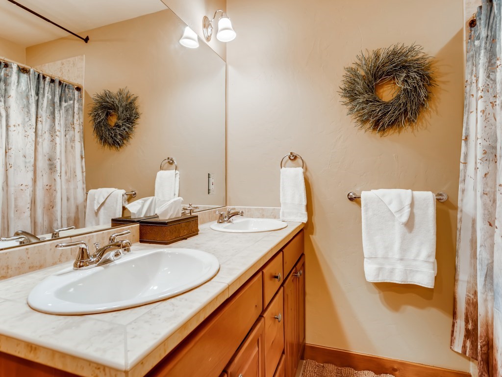344 Rena Road Breckenridge, CO 80424 - Photo 24 of 32 Guest bathroom with double sinks & tub shower combo.