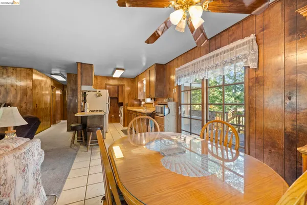 a dining room with glass top table and chairs