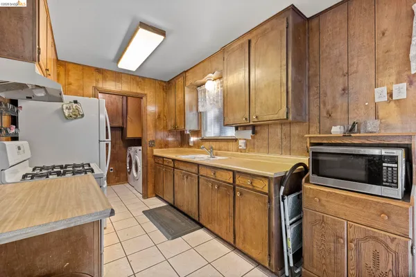 a kitchen with stainless steel appliances a stove sink and cabinets