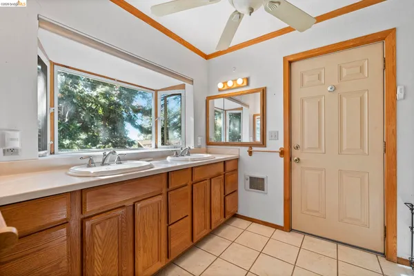 a spacious bathroom with a double vanity sink a mirror and a bathtub