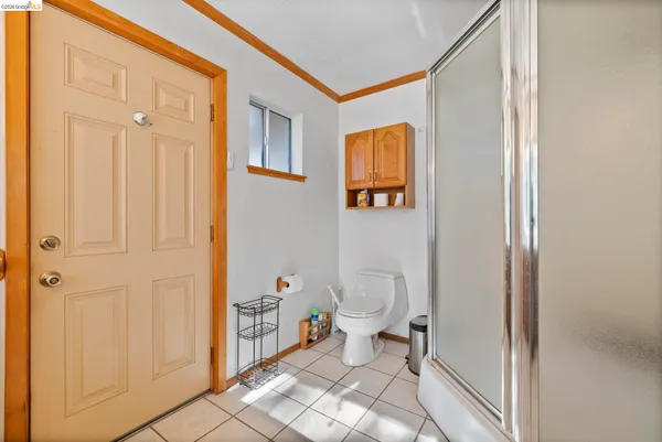 a bathroom with a toilet a sink and shower