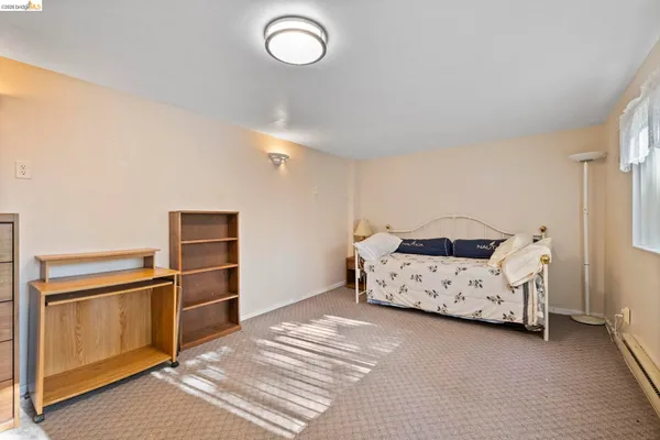 a spacious bedroom with a bed and a cabinets