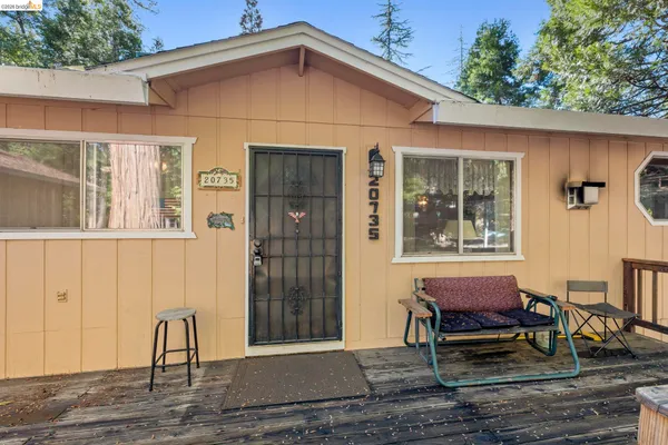 a view of a house with backyard and sitting area