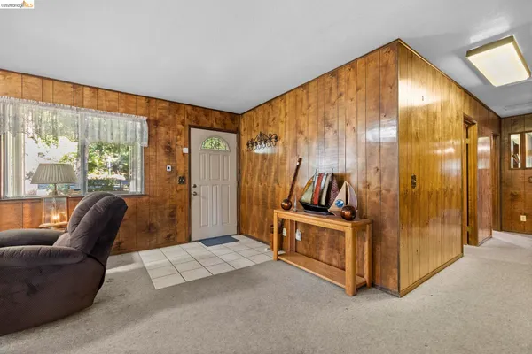 a view of a livingroom with furniture and entryway
