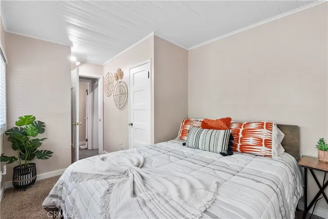 a bedroom with a bed and a potted plant
