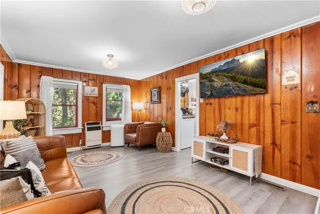 a living room with furniture and large windows