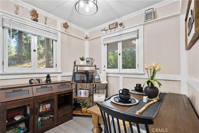 a table and chairs in a kitchen next to a window