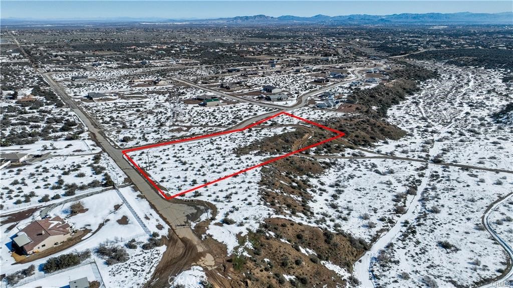 7777 Capelin Road Phelan, CA 92371 - Photo 1 of 1 an aerial view of house with yard and mountain view in back