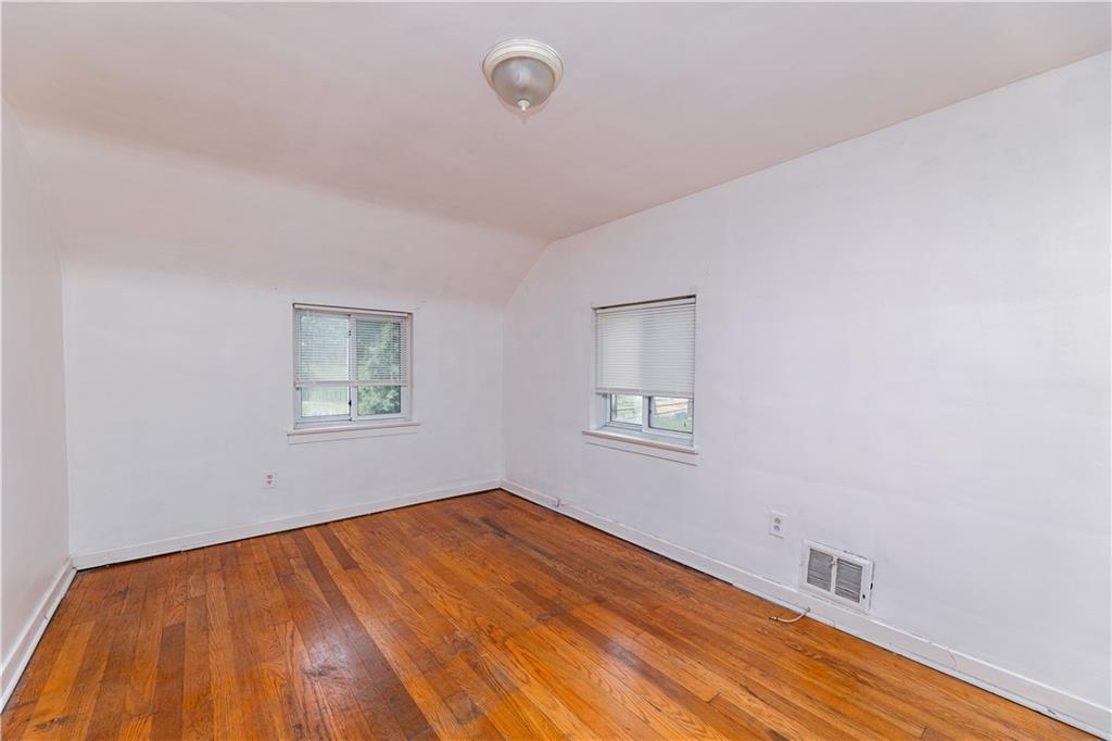 531 Beulah Road Pittsburgh, PA 15235 - Photo 13 of 32 a view of an empty room with a window and wooden floor