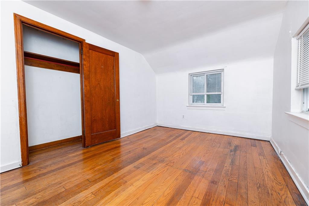 531 Beulah Road Pittsburgh, PA 15235 - Photo 14 of 32 an empty room with wooden floor and windows