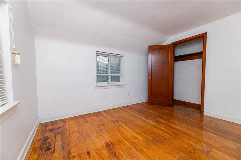 531 Beulah Road Pittsburgh, PA 15235 - Photo 19 of 32 a view of an empty room with wooden floor and a window