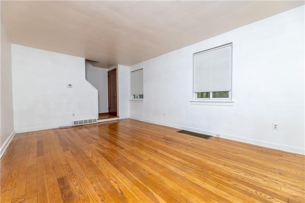 531 Beulah Road Pittsburgh, PA 15235 - Photo 3 of 32 an empty room with wooden floor and windows