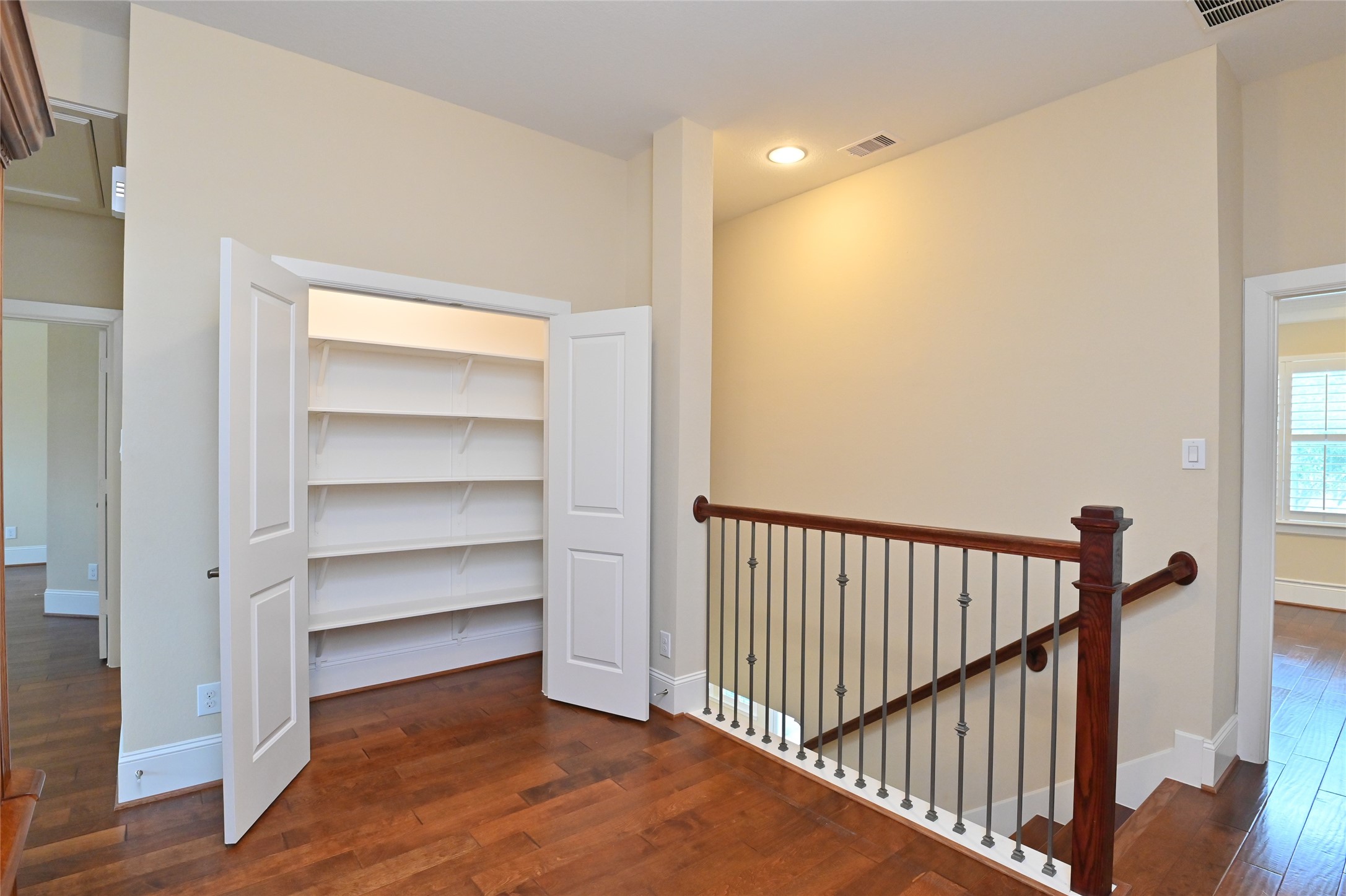 11906 McNabb Lane Houston, TX 77082 - Photo 14 of 45 a view of a hallway with wooden floor and staircase
