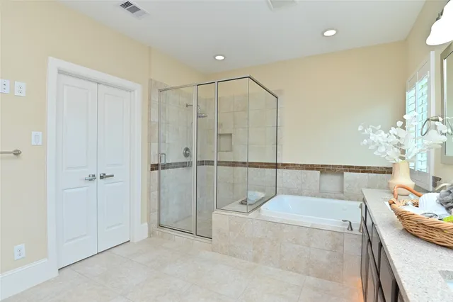 a bathroom with a tub and shower
