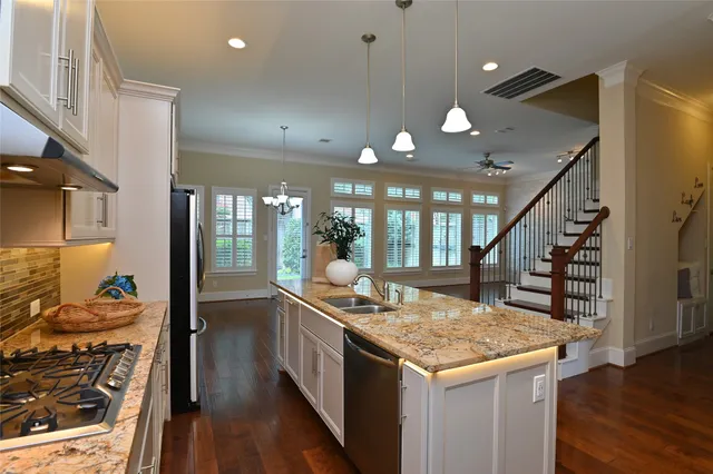 a open kitchen with stainless steel appliances granite countertop a stove and refrigerator