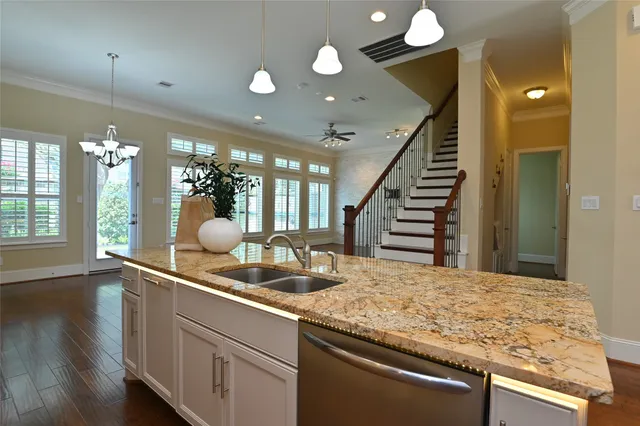 a kitchen with kitchen island a sink and a large window