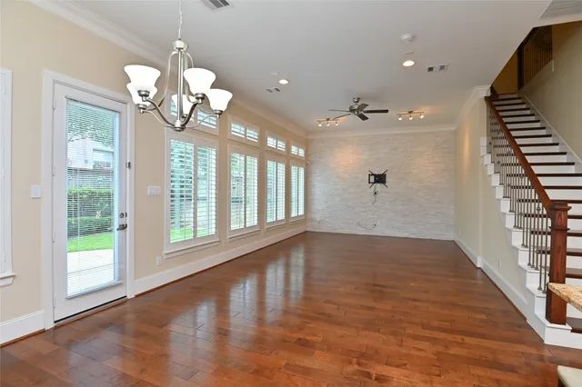 a view of a livingroom with a floor to ceiling window and wooden floor