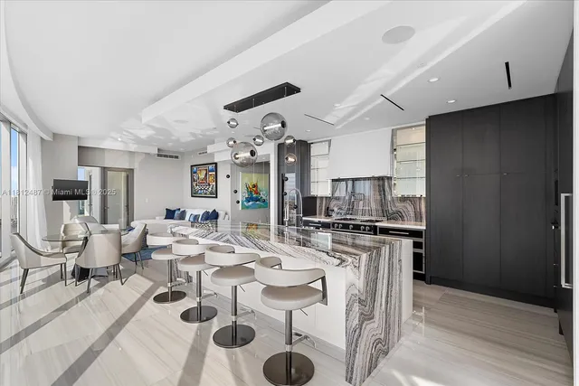 a kitchen with stainless steel appliances granite countertop a refrigerator and a stove