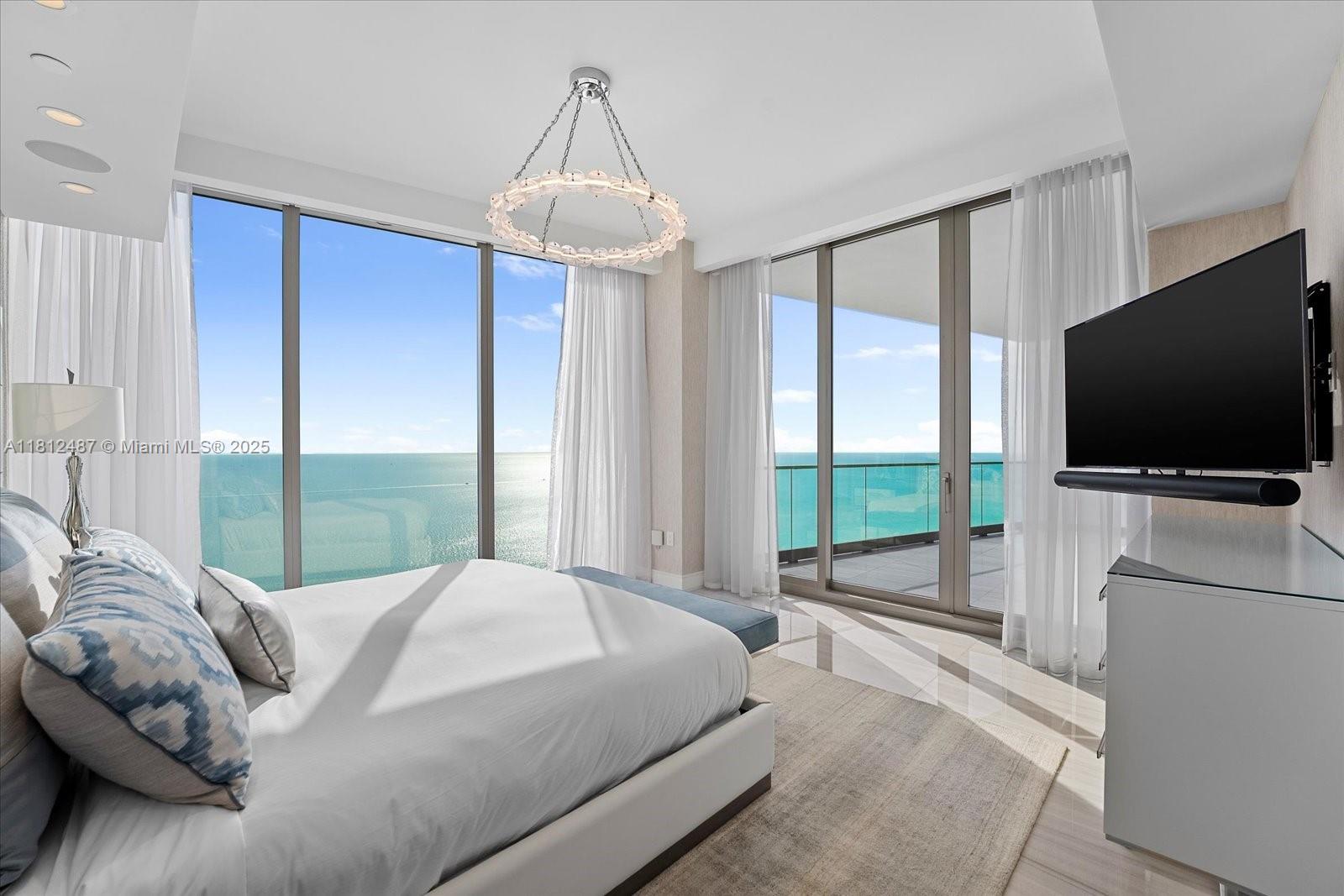 17901 Collins Avenue, Unit 3004 Sunny Isles Beach, FL 33160 - Photo 17 of 61 a bedroom with a bed and a flat screen tv