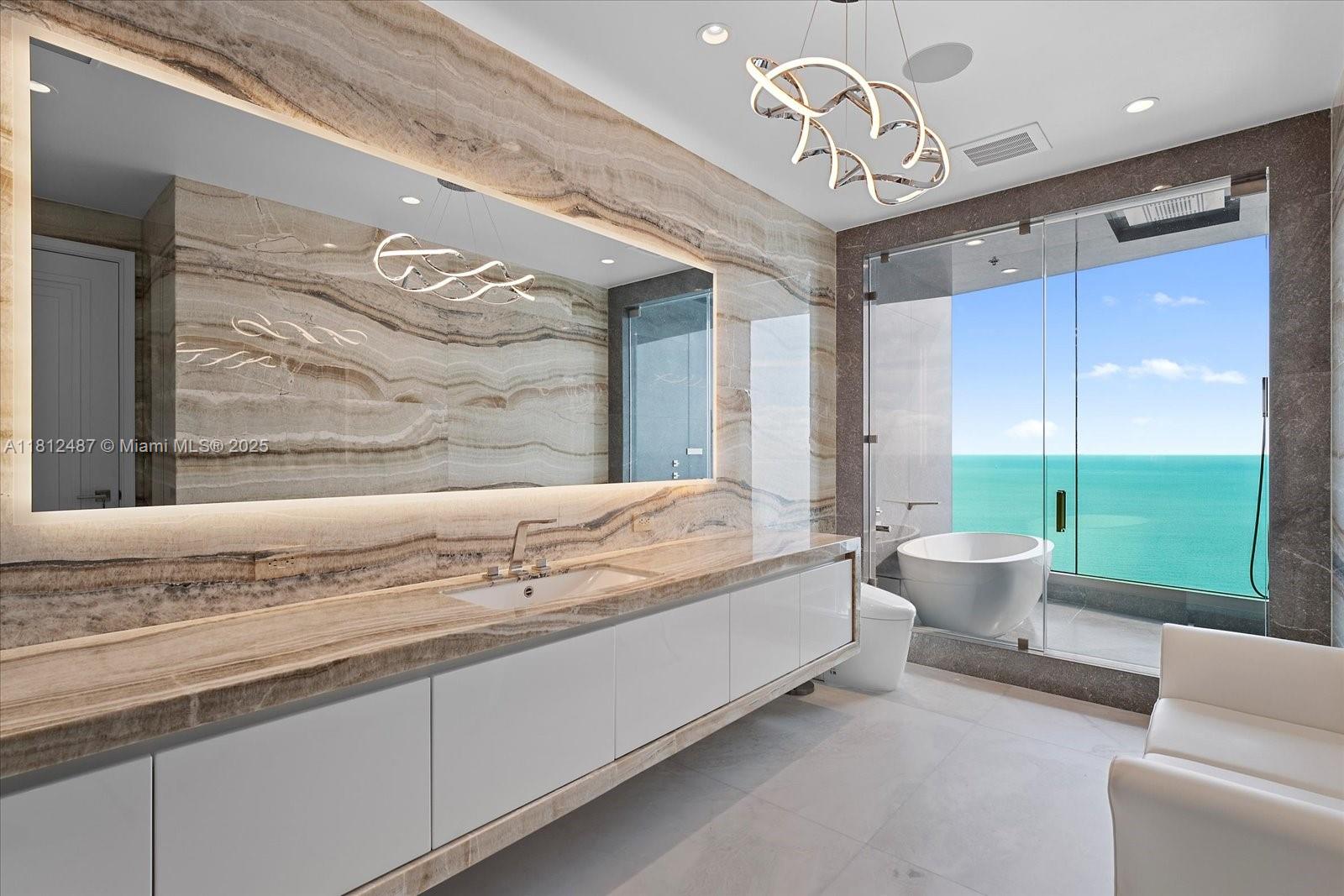 17901 Collins Avenue, Unit 3004 Sunny Isles Beach, FL 33160 - Photo 19 of 61 a spacious bedroom with a bed and ceiling fan