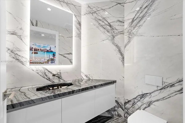 a bathroom with a toilet a sink and mirror