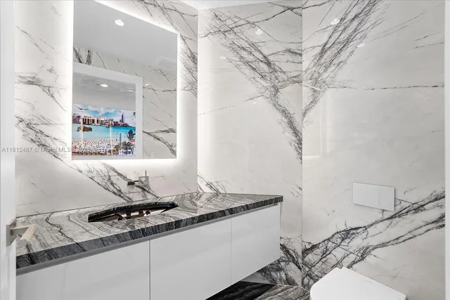 a bathroom with a toilet a sink and mirror